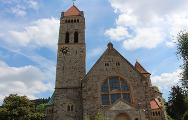 Die Front der Peterskirche vor blauem Himmel.